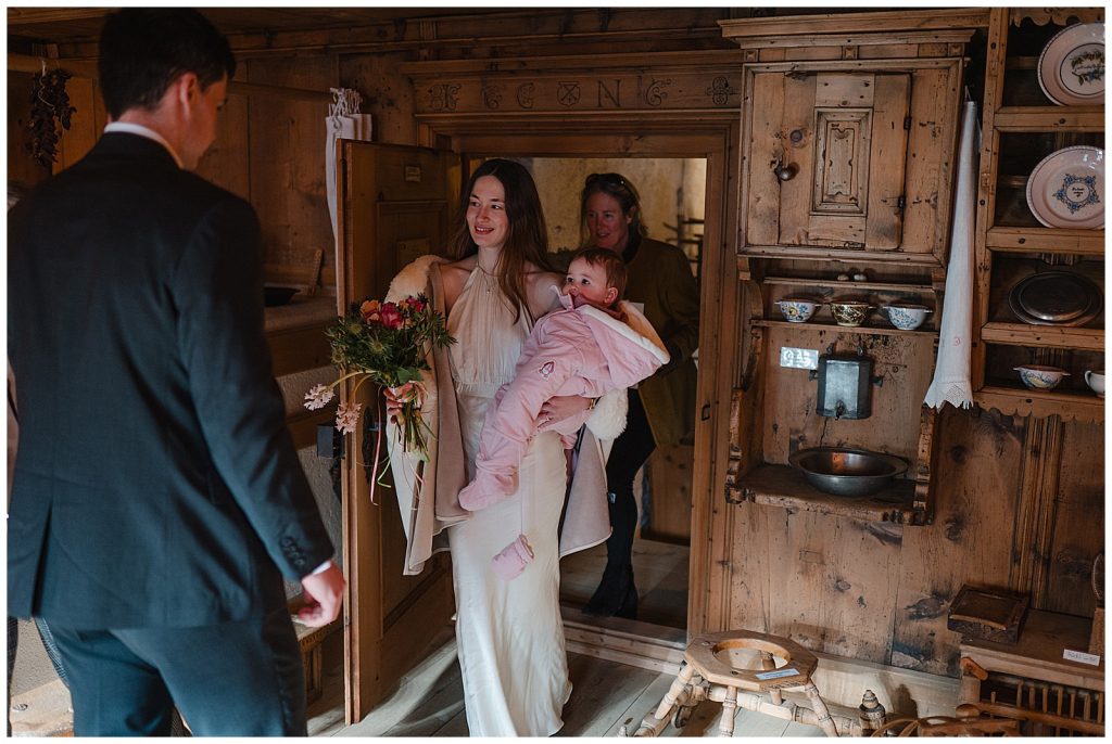 Horse-drawn carriage ride with bride groom and daughter through Klosters after ceremony